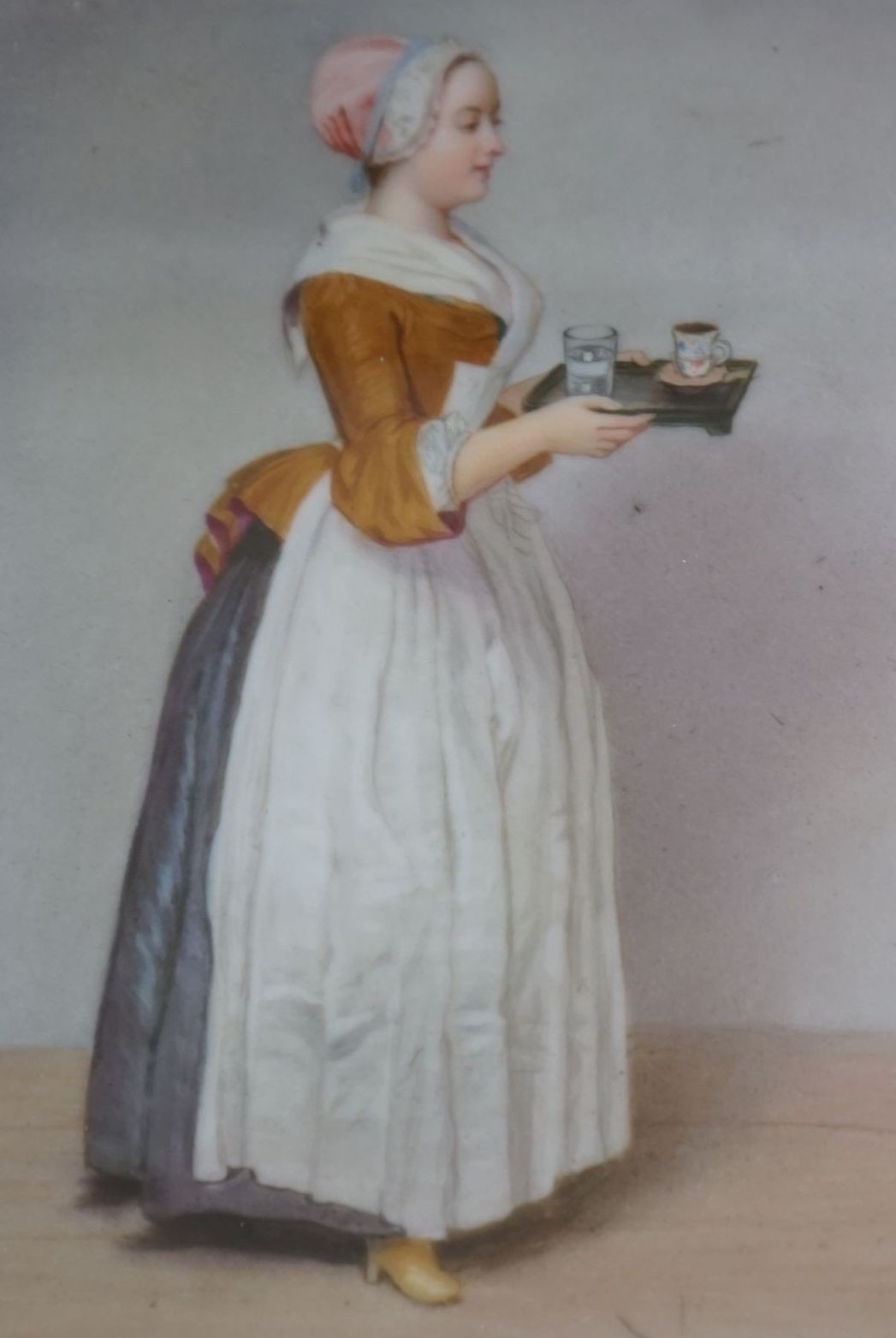 A late 19th century Dresden porcelain plaque of the chocolate girl, after Jean-Étienne Liotard, 14.5cm x 11cm